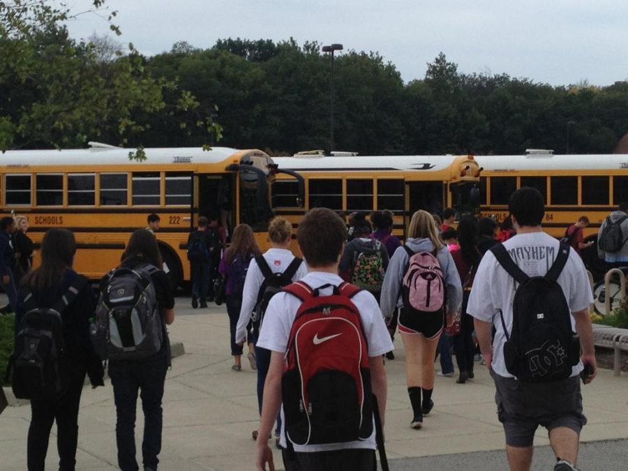 Students+walking+to+get+onto+buses+after+school