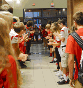 Members of leaders for fishers welcome students into the school. Picture by Michaela Breach. 