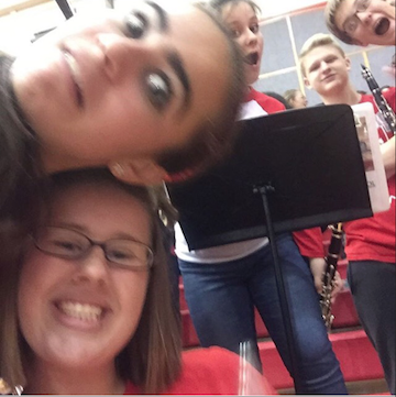 Pep band members gather for a selfie during a performance.
