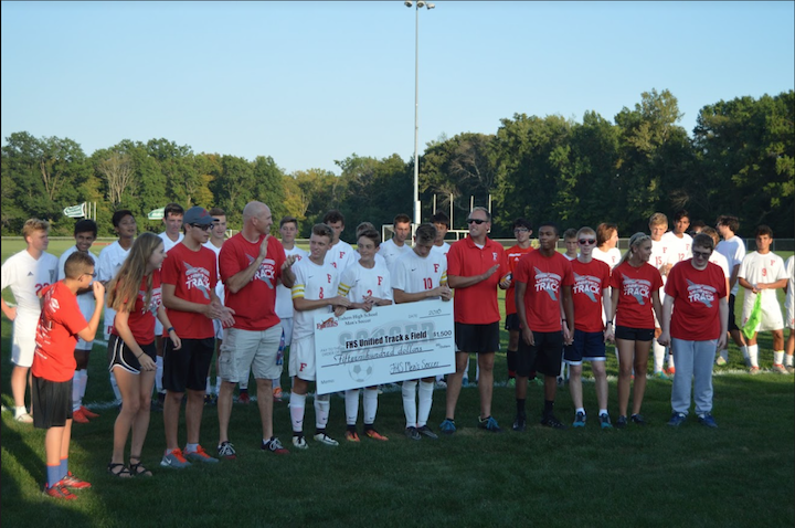 Fishers High School boys soccer raised money and  presented a check to Unified Track and Field team between their games on September 6th. Photo by Alaina Gabbard
