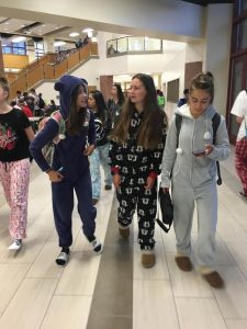 Freshmen Abby Carter, Holly Kempfer, and Emma Julien stroll the halls in their comfortable pajamas for Pajama Day on Sept 12. Photo by Lia Benvenutti. 