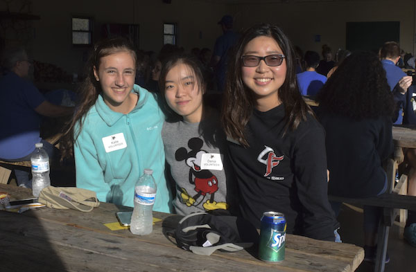 Freshmen Katie Myers, Dania Park, and Rachel Lee eat lunch during their volunteer shifts at Conner Prairie Headless Horseman. Photo by Carolina Puga Mendoza