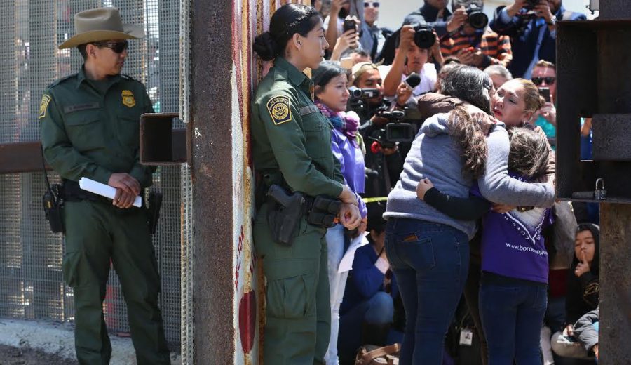 Isela Michel Zavala, left, and daughter Briana Montes embrace Yudridia Guadalupe Zavala as they meet in the Door of Hope at Borderfield State Park in San Diego on April 30, 2016.  Photo courtesy of the Tribune News Service.