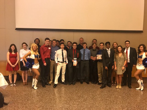 The economics team poses poses with two Indianapolis Colts cheerleaders after its state competition on April 13, 2017.