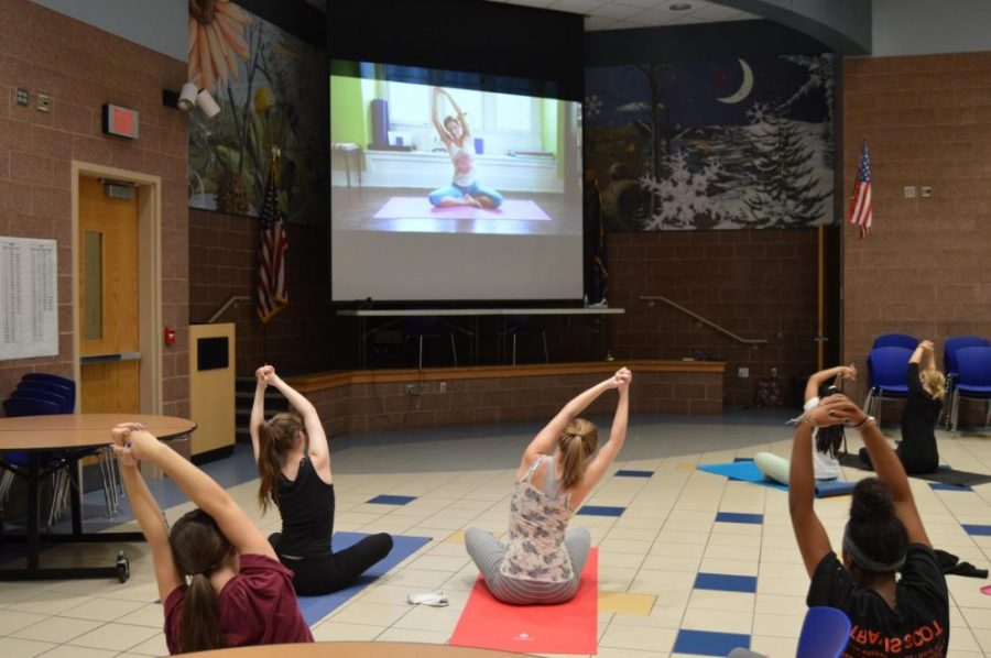 Club members follow a video by actress Adriene Mishler on August 31.  Photo by Sydney Greenwood.