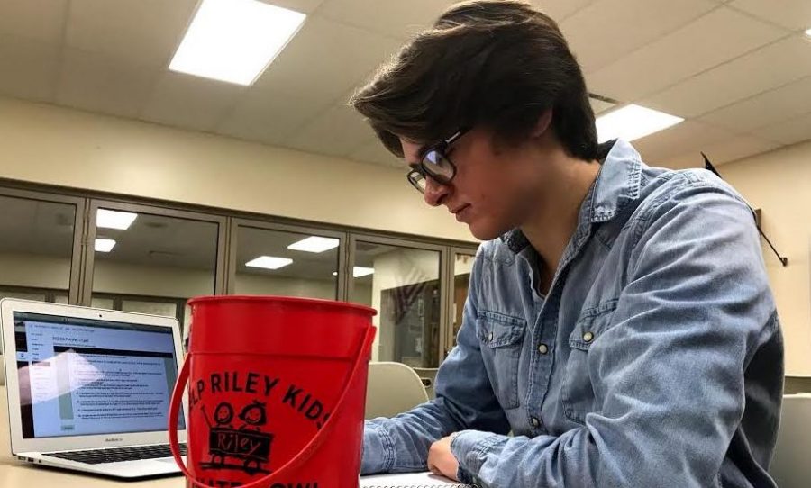 Junior Ross Delong puts his Riley Kids bucket on his desk on Nov. 1 to inform people that he is a campaign manager, raising donations for senior Brayton Wilds.