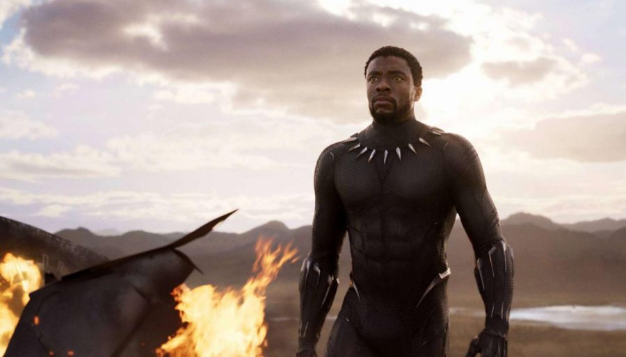 Chadwick+Boseman+as+the+Black+Panther+stands+tall+by+a+flaming+plane+as+his+enemies+approach+him.+Photo+used+with+permission+of+Tribune+News+Service.++