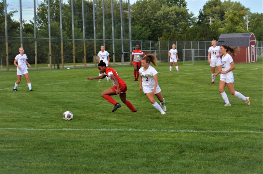 Junior Taryn McFarland takes the ball away from the sideline, but the Millers keep all of her exits covered in a 5-2 finish on Aug,29.