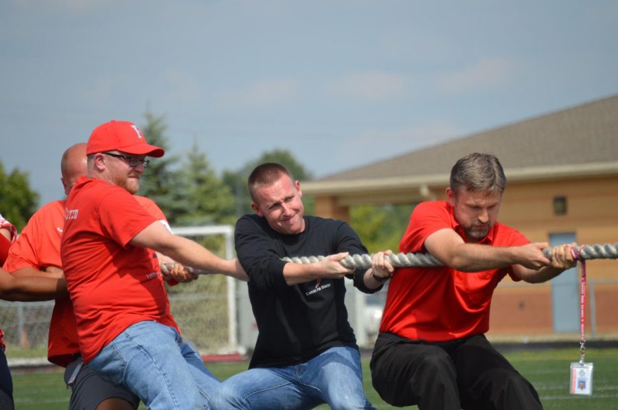 Assistant principal Kyle Goodwin, who was an English teacher at the time, fights to win the classic tug-of-war against his colleagues in the 2016 Homecoming Pep Rally.