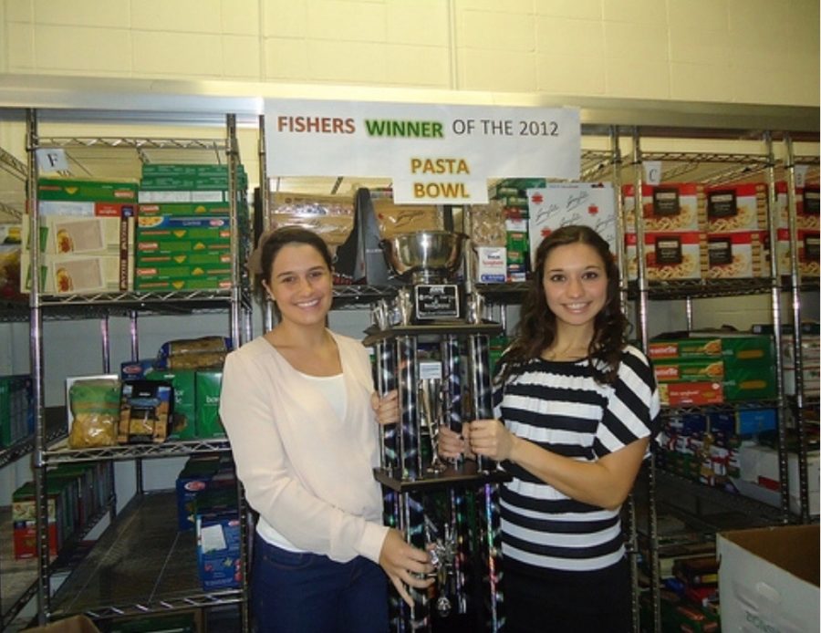 Katie Lipke and Erin Lattimer holding the Pasta Bowl trophy at Second Helpings to celebrate their first victory in 2012.