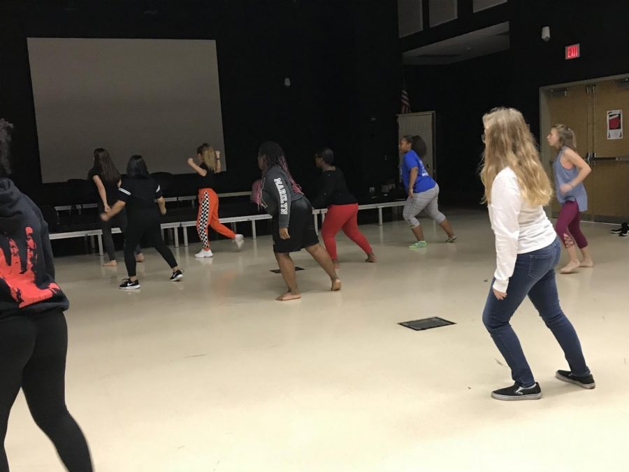 Members of the Dance Explosion club practice choreography for one of their first shows in the black box theater after school on Oct. 24.