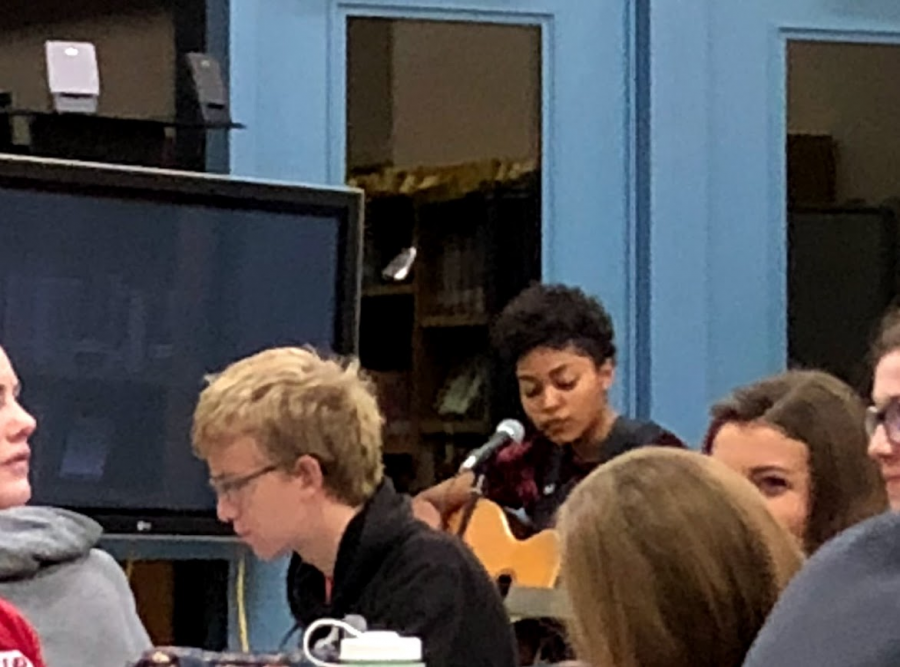 Senior Hedessa Henry strums her guitar while singing Demi Lovatos Skyscraper into her microphone in the media center on Oct. 5.