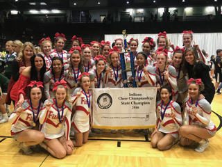 The cheer team stands alongside their state trophy after the awards ceremony on Nov. 4