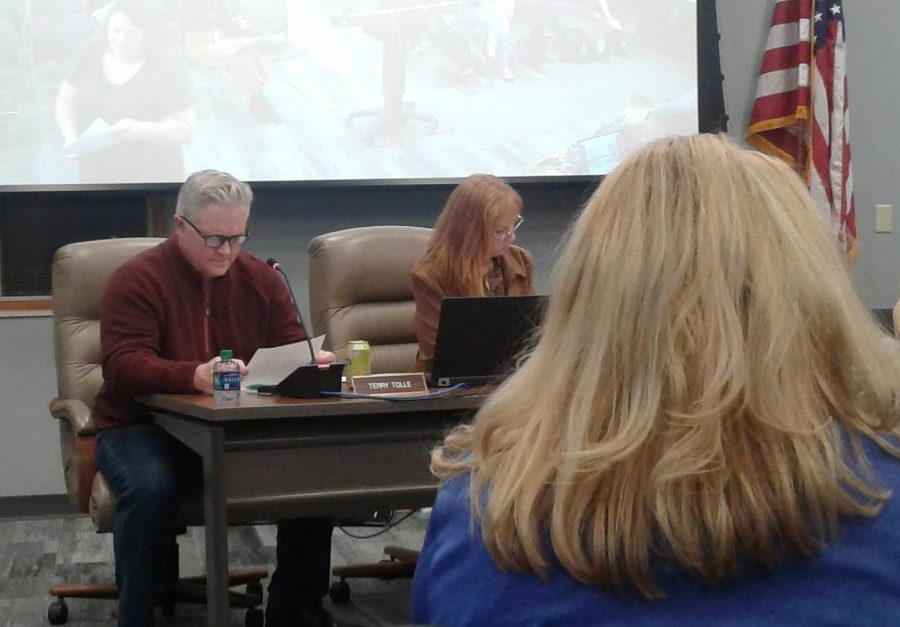 Board members Terry Tolle and Amanda Shera read over a paper one of the speakers handed out which outlined their points at the HSE redistricting final meeting on Dec. 12. 