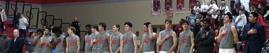 The Varsity team sings the pledge of the allegiance prior to their senior night game on Feb. 10. 