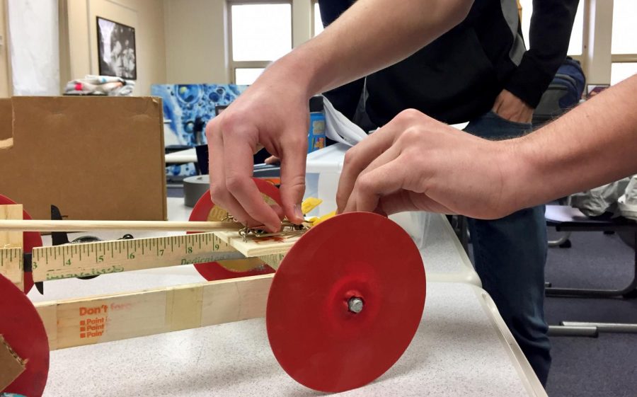 Junior Collin Tully prepares the “Mousetrap Vehicle” for a test run on Feb. 26 in room B214.
