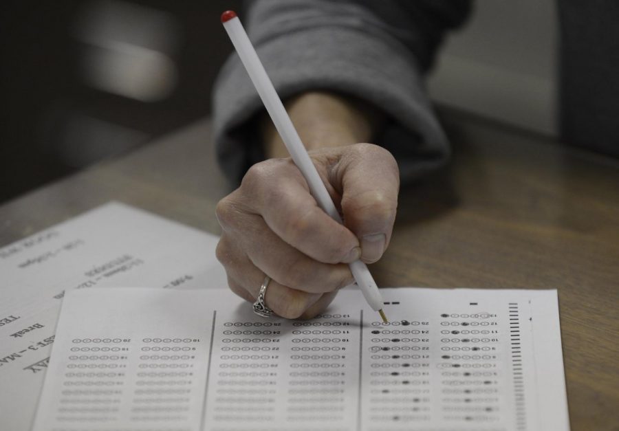 A  test taker  bubbles in her answer sheet, which has become antiquated at the rise of digital state standardized testing.         
