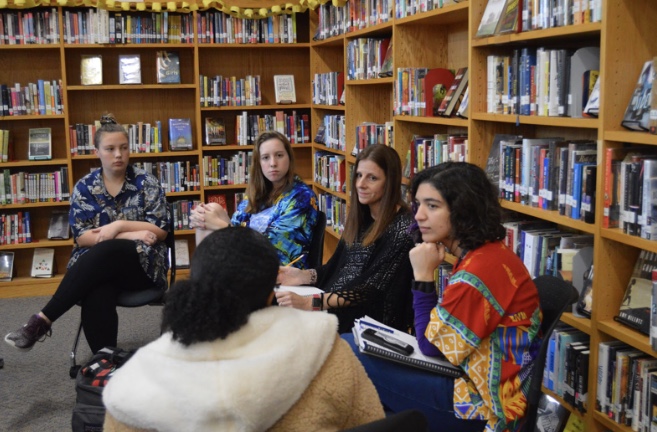 Sophomore Kelsey Ortell, senior Whitney Roberts, and junior Meron Washington discuss equity issues with Mrs. Isom and Mrs. Greco in the Library on Dec. 13. Photo by Quinn Lowry
