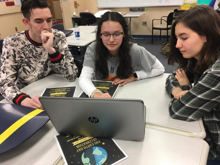 From left to right, junior Brian Davis, junior Tatiana Pardo, and sophomore Chloe Chamberlin prepare for the Earth Day event on April 17.