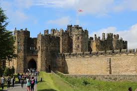 Tourists enter the front gate of Alnwick Castle in Englands Northumberland county.
