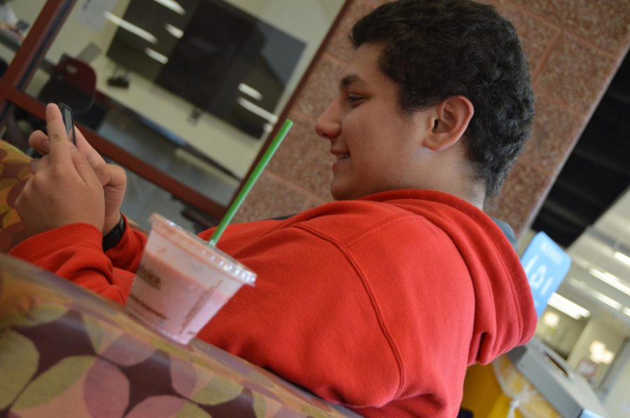 Senior Jared Hyatt drinks a smoothie from the CCA with a plastic straw.