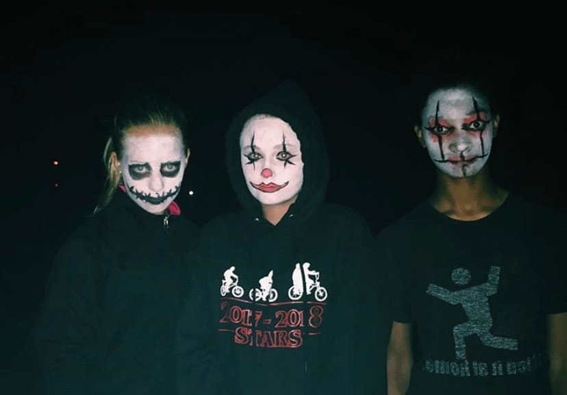 Freshmen Jillian Hooton and Maddie Marryman and Sophomore Anna Ware have their faces painted to scare people at the Haunted Trail.