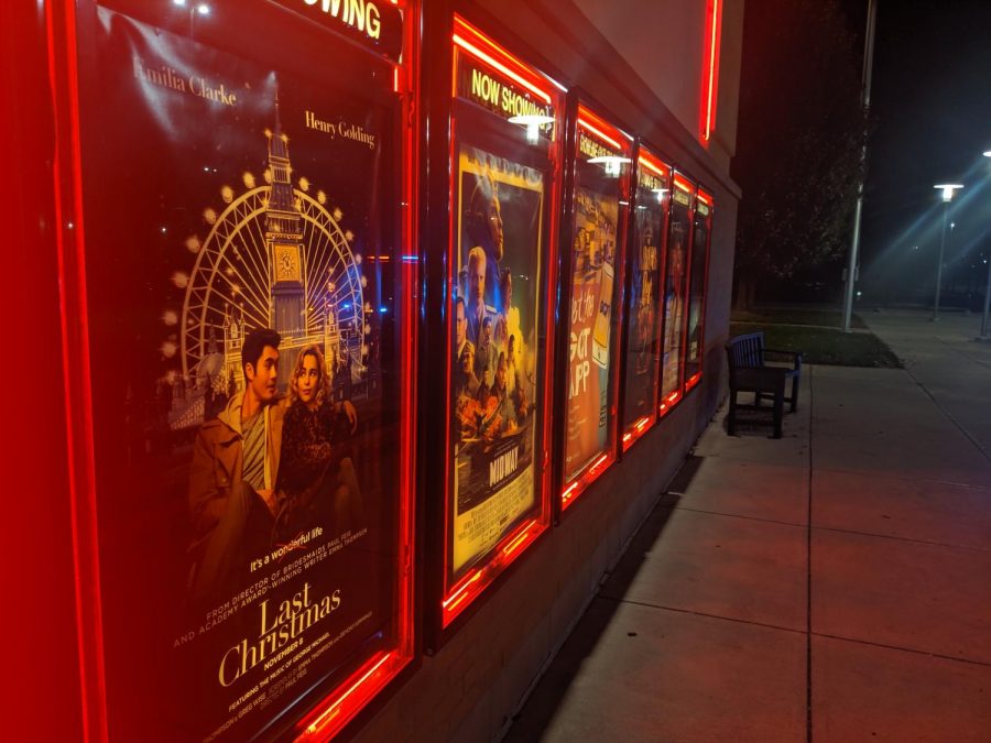 The poster for Last Christmas appears at the local movie theater, along with several others.