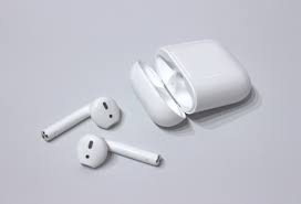 Airpods sitting on a desk.