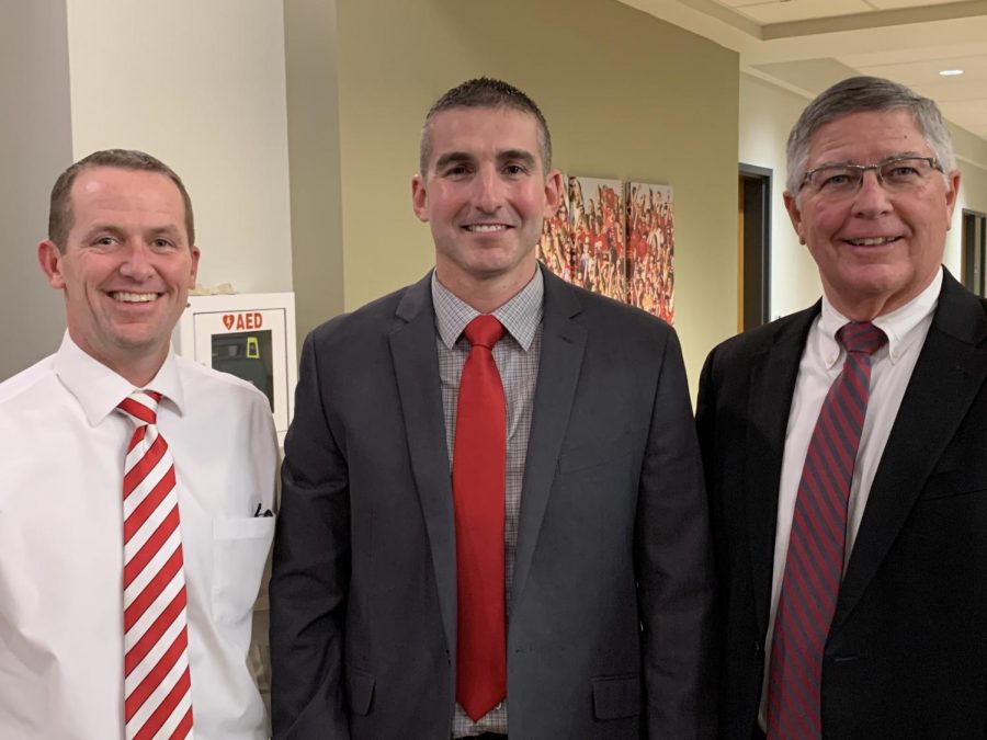 From the left, Robert Seymour, Coach Curt Funk and James Brown take a photo together after Funk was approved as the new head football coach. Photo used with permission of Principal Jason Urban. 