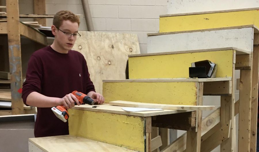 On Jan. 28, freshman Zach McEwen works on adding bracing to his curved stairs to add stability. 