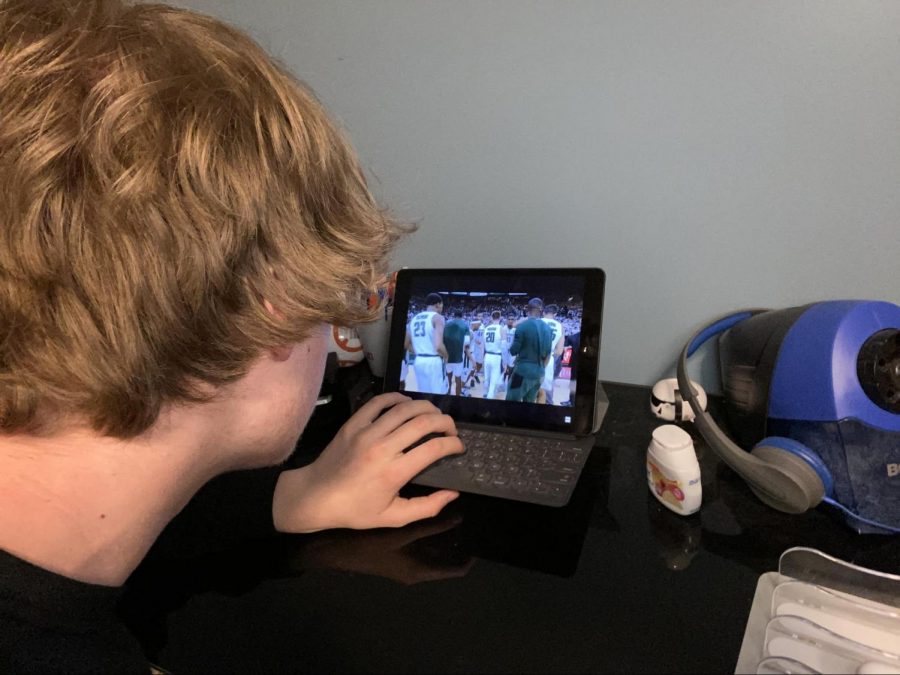 Junior Andrew Feuerstine watches clips of his favorite college basketball moments on Mar. 25 since the tournament was canceled. 