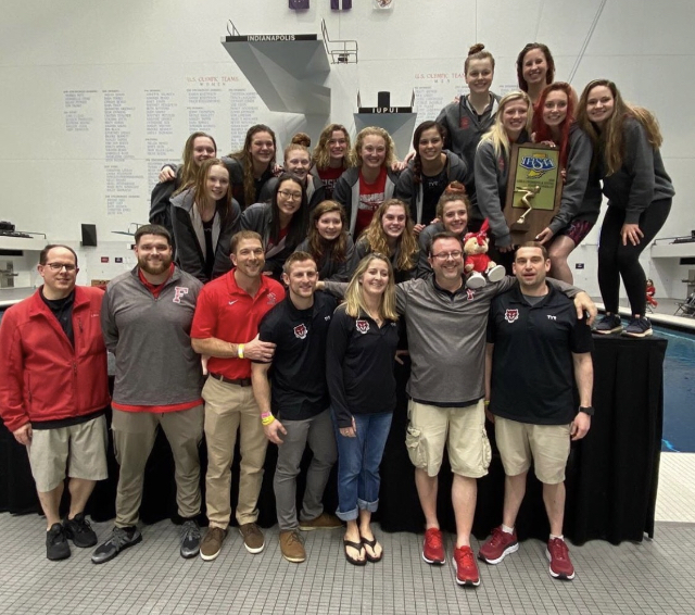The girls swimming and diving team stands on the podium after finishing runner-up at the 2020 IHSAA State Championship at the IUPUI Natatorium on Feb. 15, 2020.