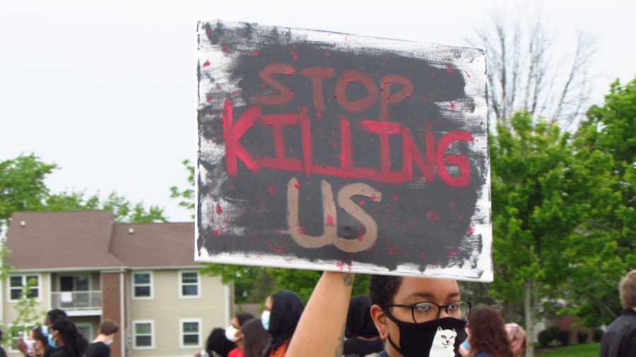 A protester holds up a sign at the protest on June 1. which took place at the Nickel Plate Amphitheater in Fishers.