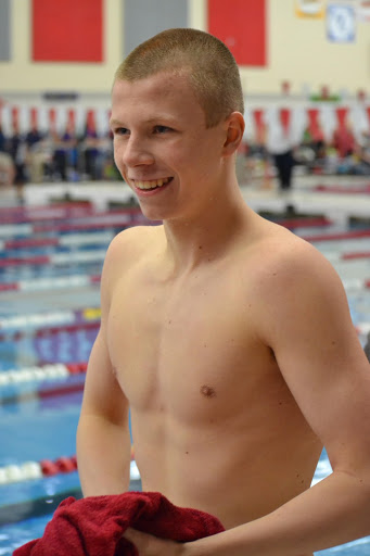 Ponsler walks to the deck before the 400 freestyle relay at the sectionals meet on Feb. 22, 2020.