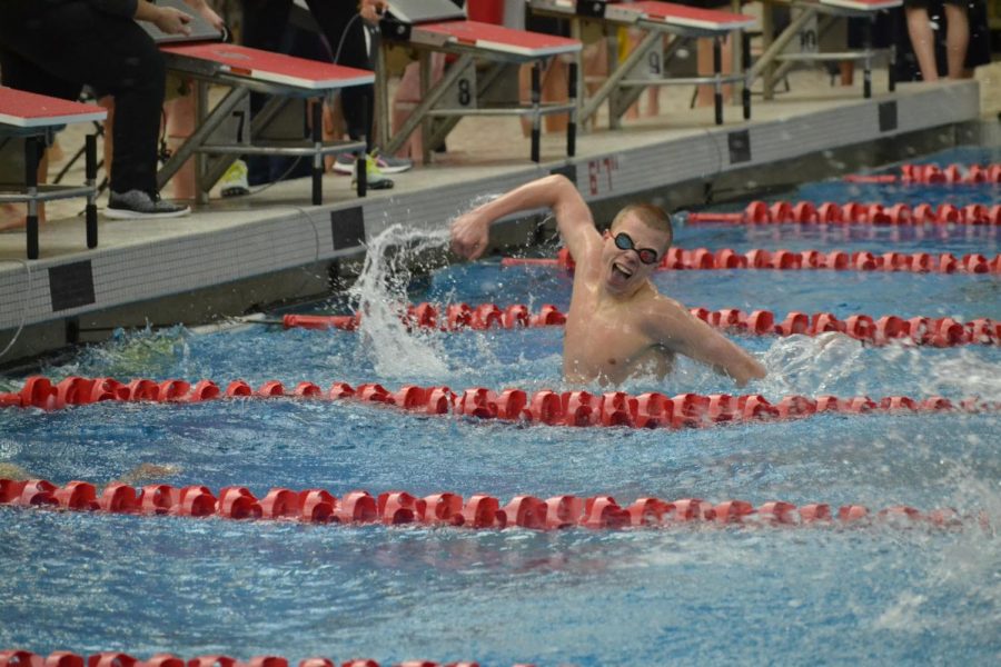 Junior Kyle Ponsler splashes water in celebration after winning the 200 freestyle relay against rival HSE at the sectionals meet on Feb. 22, 2020. Ponsler set new pool and school records for the race at the meet. 