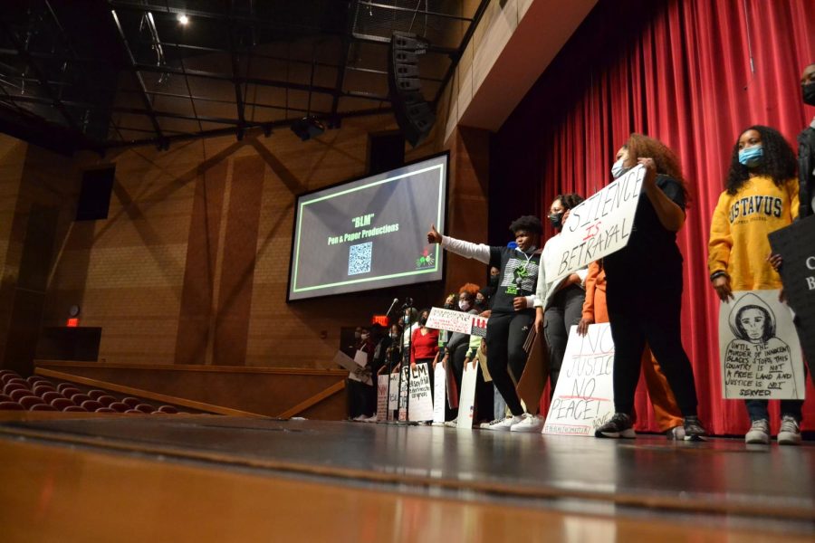 Future Black Leaders club members hold up signs supporting the Black lives matter protest. A performance featuring sophomore Isaiah Webb during the rehearsals for Black Heritage Celebration on Feb. 16. 