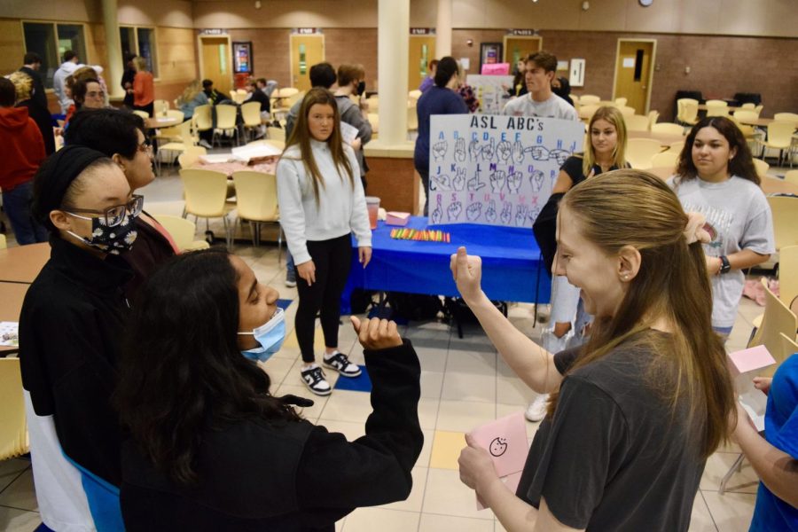 ASL students teach participants how to sign their names during Education Explosion on Thursday, April 14. 