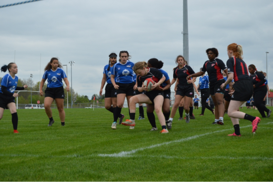 On May 4, the Mudsock rugby team rushes to tackle a player on the Pike team. The tackle stopped forward progress of the ball, and the Pike team was forced to set up a ruck.