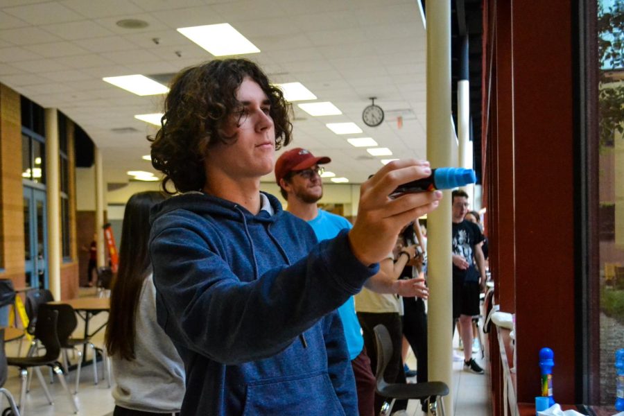 Senior Brady Dack prepares to begin sketching a design onto his assigned window. “The best part of decorating was getting to see everyone else’s artistic talents come together and make something that we were all super proud of,” junior Ava Gwin said about the event. The window decorating event took place Sept. 11.