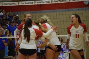 Team members seniors Ava Vickers, Margo Hernandez and Brynn Zastrow and sophomores Ellen Roberts and Jules Kellogg celebrate at the volleyball mudsock game against HSE on Thursday at FHS. 