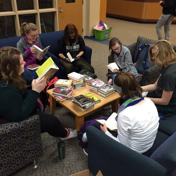 Members of book club pick up new books to review and discuss for the LMC. Photo courtesy of Renee Isom 