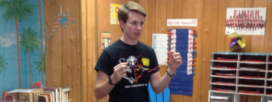 Senior Alex Chrisman explains elements of robot design to a fourth grade class at New Britton Elementary school. Photo courtesy of Hannah Marrs.