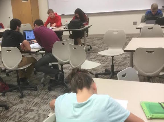 Math teacher Ryan Duffy assists students at math tutoring after school on Tuesday. Photo by Ethan O'Sullivan. 