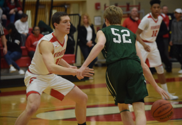 Senior Connor Washburn guards Pendleton heights player on Feb. 10. Tigers won 63-49. Photo used with permission of Fishers High School athletic website. 