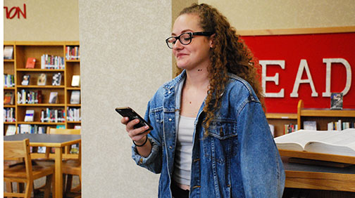 Junior Taylor Treeger reads one of her works aloud during a meeting of the Poetry Club. Photo used with permission of Claire Castillo.