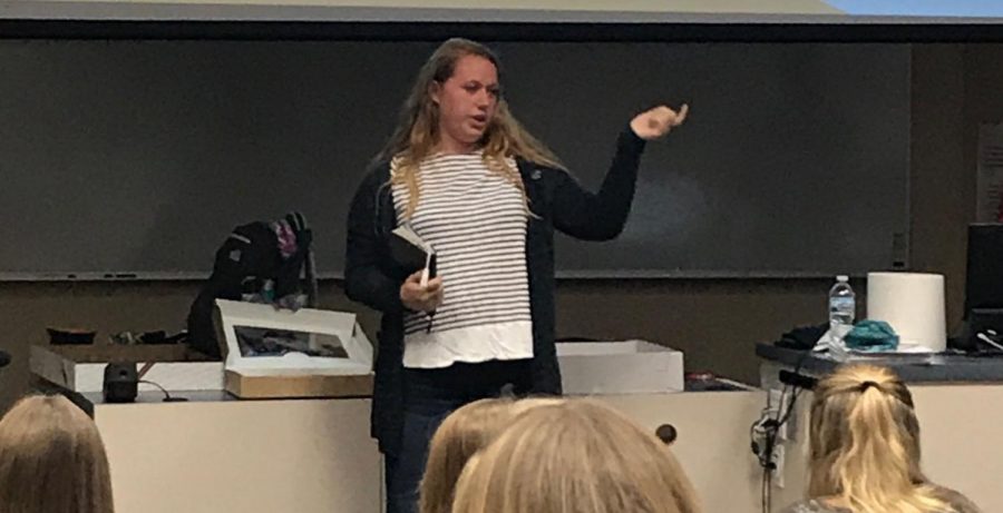 Softball player senior Sydney Milburn shares scripture to FCA club members at an FCA meeting in the LGI on Tuesday Oct. 3. Photo used with permission of London Osmun.