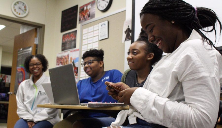 ​Sophomore Zoie King and juniors Danielle Bellamy, Deshonte Bogle and Aliese Harris discuss plans for the upcoming winter dance at a Future Black Leaders of America meeting on Jan. 10.  Photo by Mia Morales.

