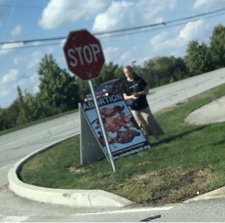 A+member+of+created+equal+stands+by+a+sign++that+depicts+fetuses+after+an+abortion%2C+that+has+been+placed+directly+under+a+stop+sign+outside+of+the+CCA+entrance+on+Oct.+3.