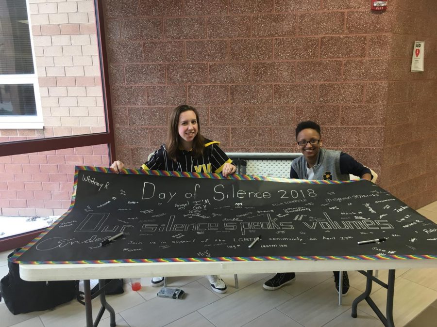 GSA president senior Whitney Roberts and member senior Jordan Cabico complete a signed banner for the day of silence. 