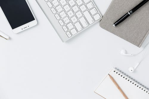 Common items used for business strewn about a desk.